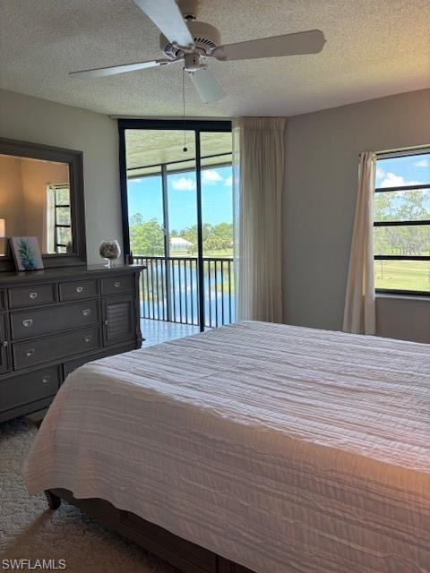 413 Augusta Boulevard, Unit 306 Naples, FL 34113 - Photo 17 of 31 a bedroom with a bed and a large window