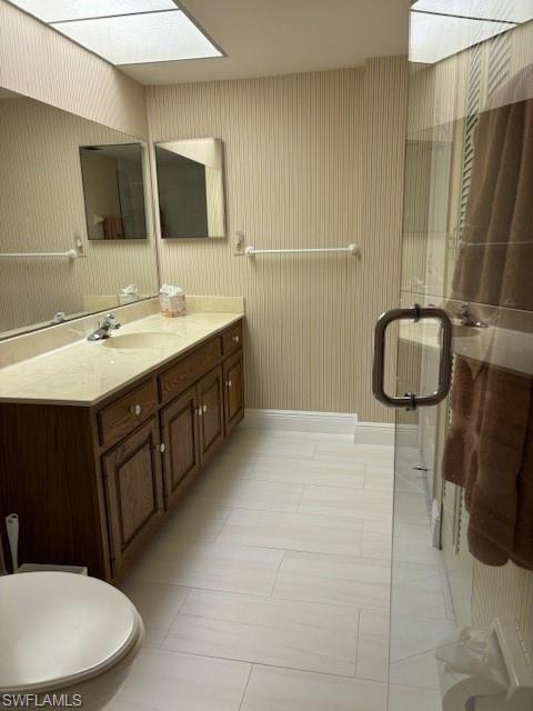 413 Augusta Boulevard, Unit 306 Naples, FL 34113 - Photo 20 of 31 a bathroom with a double vanity sink toilet and mirror