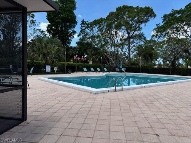 413 Augusta Boulevard, Unit 306 Naples, FL 34113 - Photo 28 of 31 a view of a swimming pool with a yard