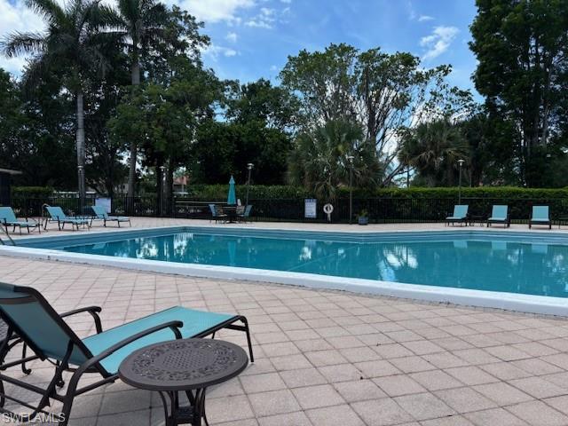 413 Augusta Boulevard, Unit 306 Naples, FL 34113 - Photo 30 of 31 a view of a table and chairs in the patio