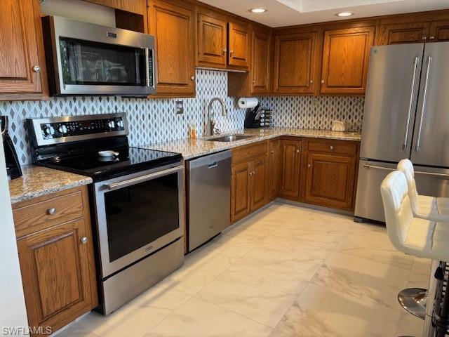 413 Augusta Boulevard, Unit 306 Naples, FL 34113 - Photo 6 of 31 a kitchen with stainless steel appliances granite countertop a stove a sink and a microwave