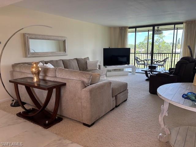 413 Augusta Boulevard, Unit 306 Naples, FL 34113 - Photo 8 of 31 a living room with furniture and a flat screen tv