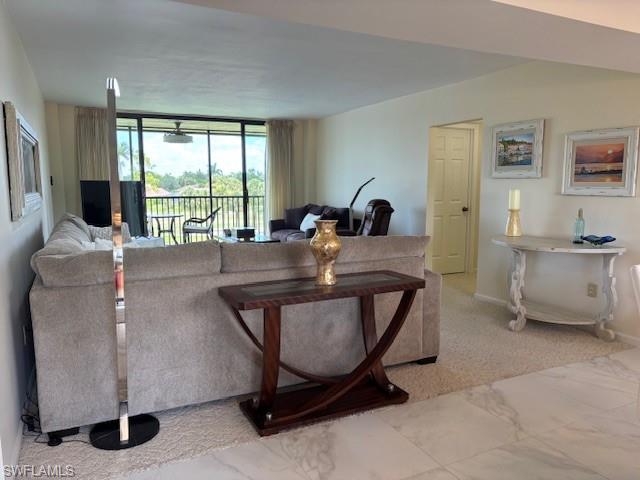 413 Augusta Boulevard, Unit 306 Naples, FL 34113 - Photo 9 of 31 a work room with furniture and a large window
