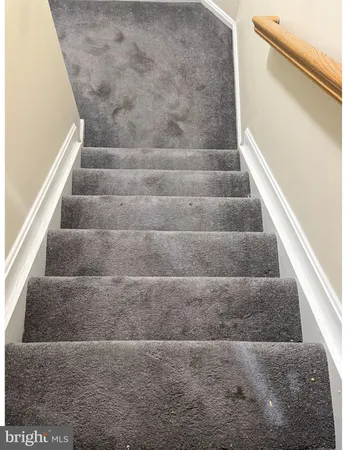 a view of staircase with white walls