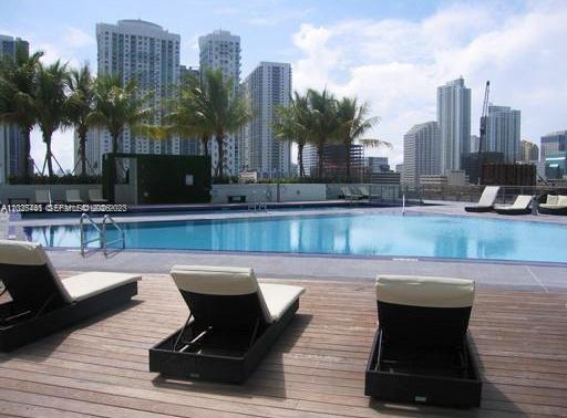 90 Southwest 3rd Street, Unit 3708 Miami, FL 33130 - Photo 3 of 13 a swimming pool with outdoor seating and city view