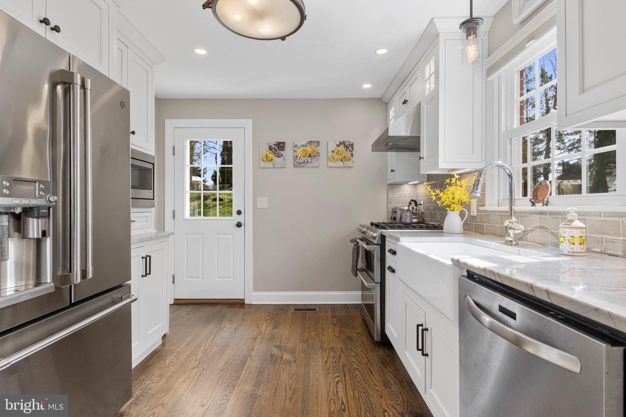 409 Paddock Road Havertown, PA 19083 - Photo 27 of 47 a kitchen with granite countertop a refrigerator and a sink
