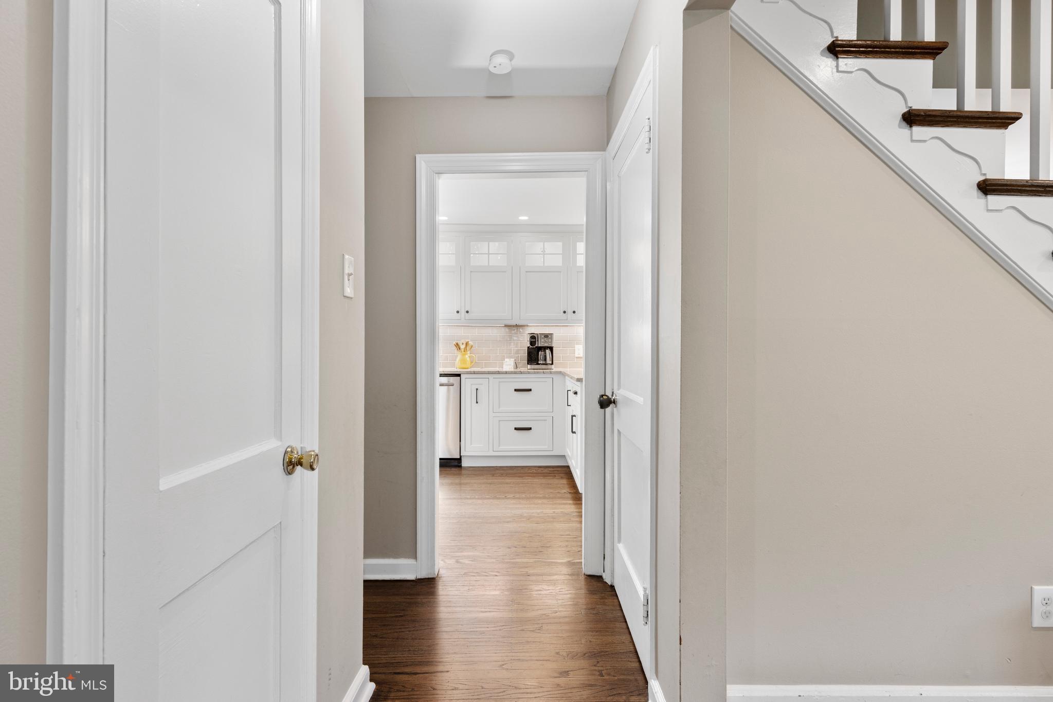 409 Paddock Road Havertown, PA 19083 - Photo 34 of 47 a view of a hallway with wooden floor a bathroom and a sink