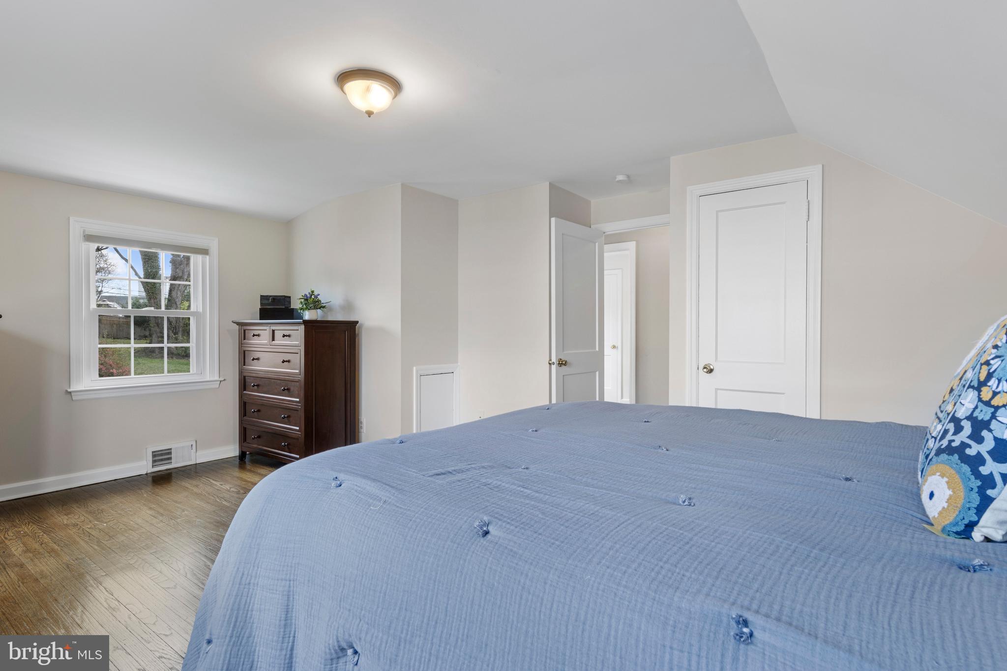 409 Paddock Road Havertown, PA 19083 - Photo 38 of 47 a bedroom with a bed and wooden floor