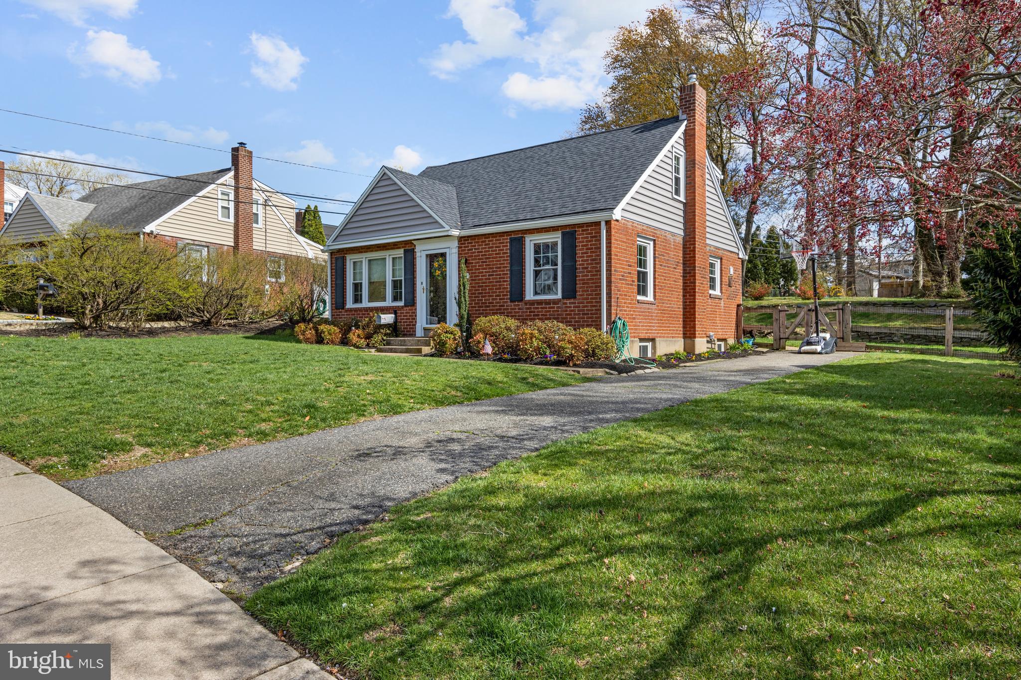 409 Paddock Road Havertown, PA 19083 - Photo 5 of 47 a front view of a house with a yard