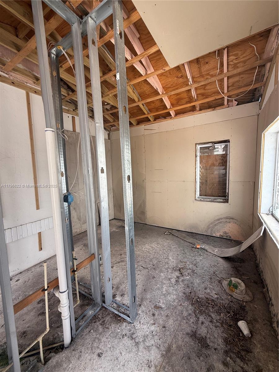 751 Northeast 70th Street Miami, FL 33138 - Photo 17 of 25 an empty room with wooden floor and windows