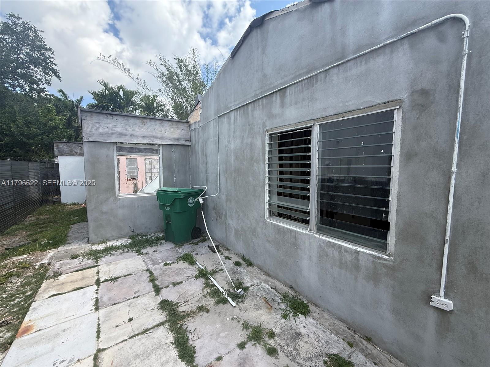 751 Northeast 70th Street Miami, FL 33138 - Photo 20 of 25 a view of a backyard with a large tree