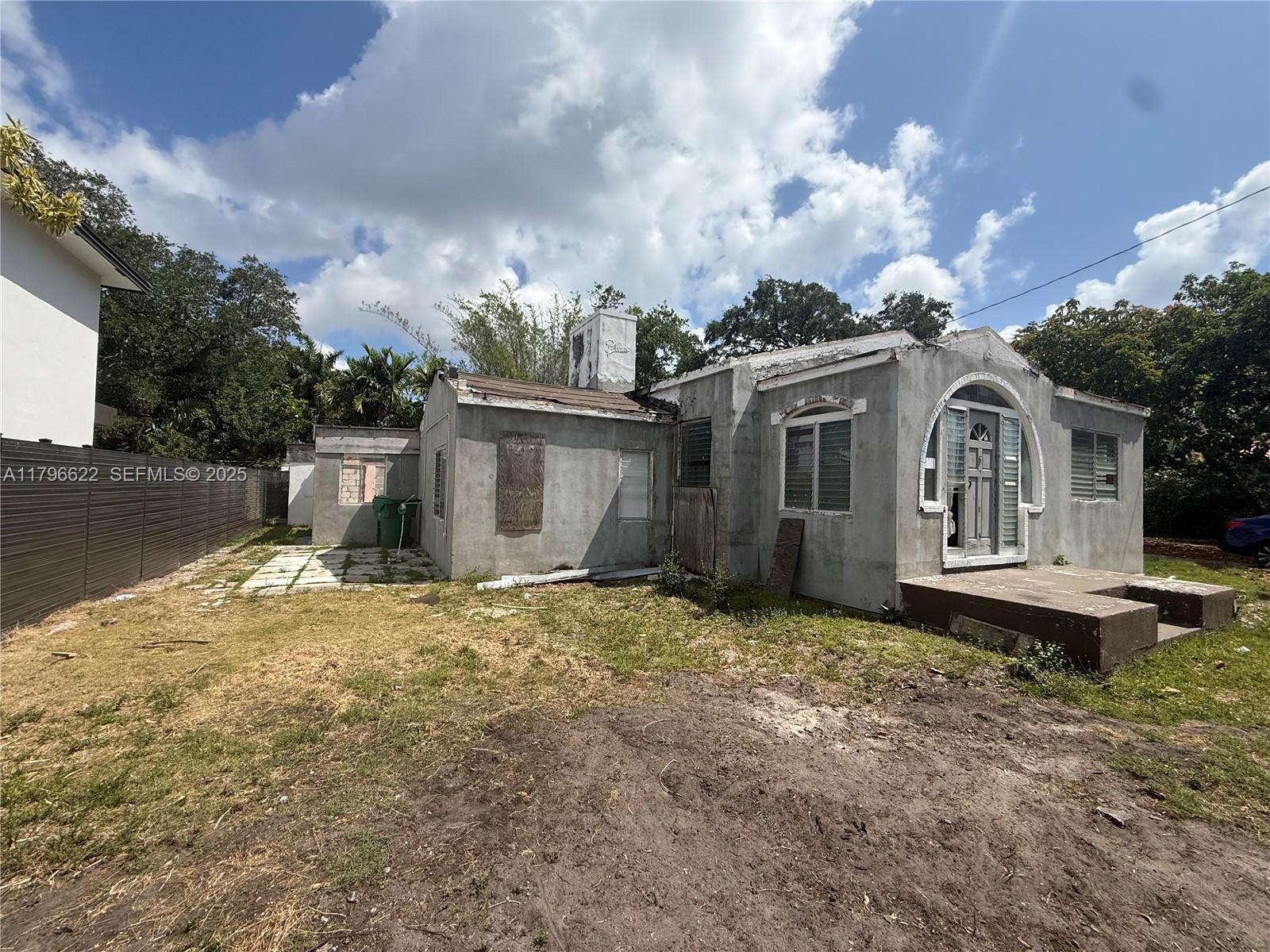 751 Northeast 70th Street Miami, FL 33138 - Photo 24 of 25 a view of a house with backyard and garden