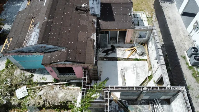 an aerial view of a house with table and chairs