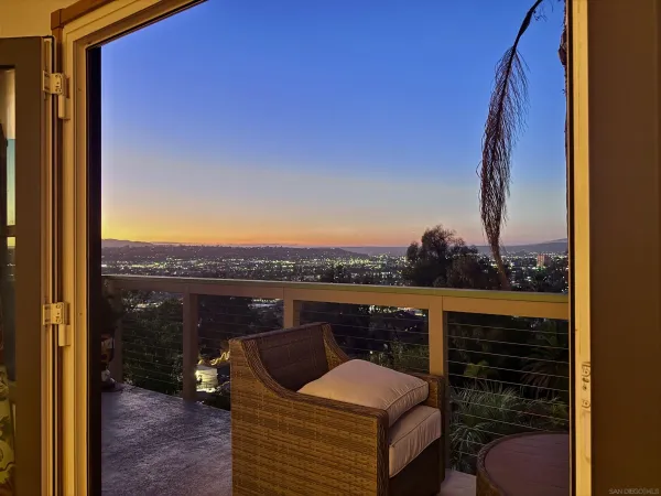 a view of roof deck with couches and wooden floor