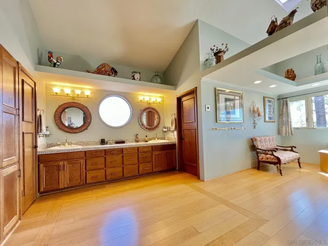 a spacious bathroom with a granite countertop sink and a mirror