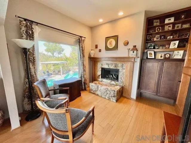a living room with furniture a window and a fireplace