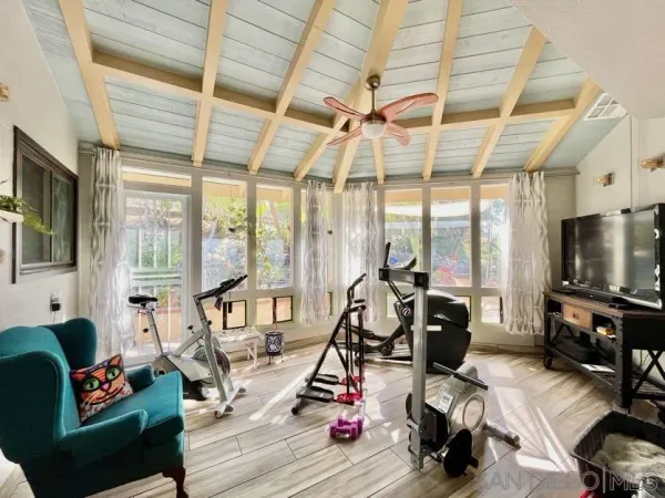a view of a livingroom with furniture wooden floor and a window
