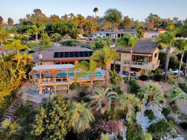 an aerial view of multiple houses with a yard