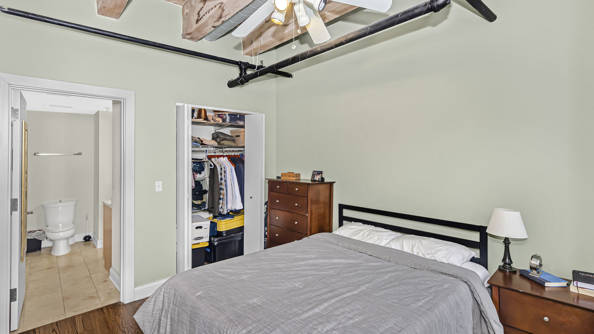 106 North Aberdeen Street, Unit 4G Chicago, IL 60607 - Photo 12 of 22 a bedroom with a bed and a walk in closet