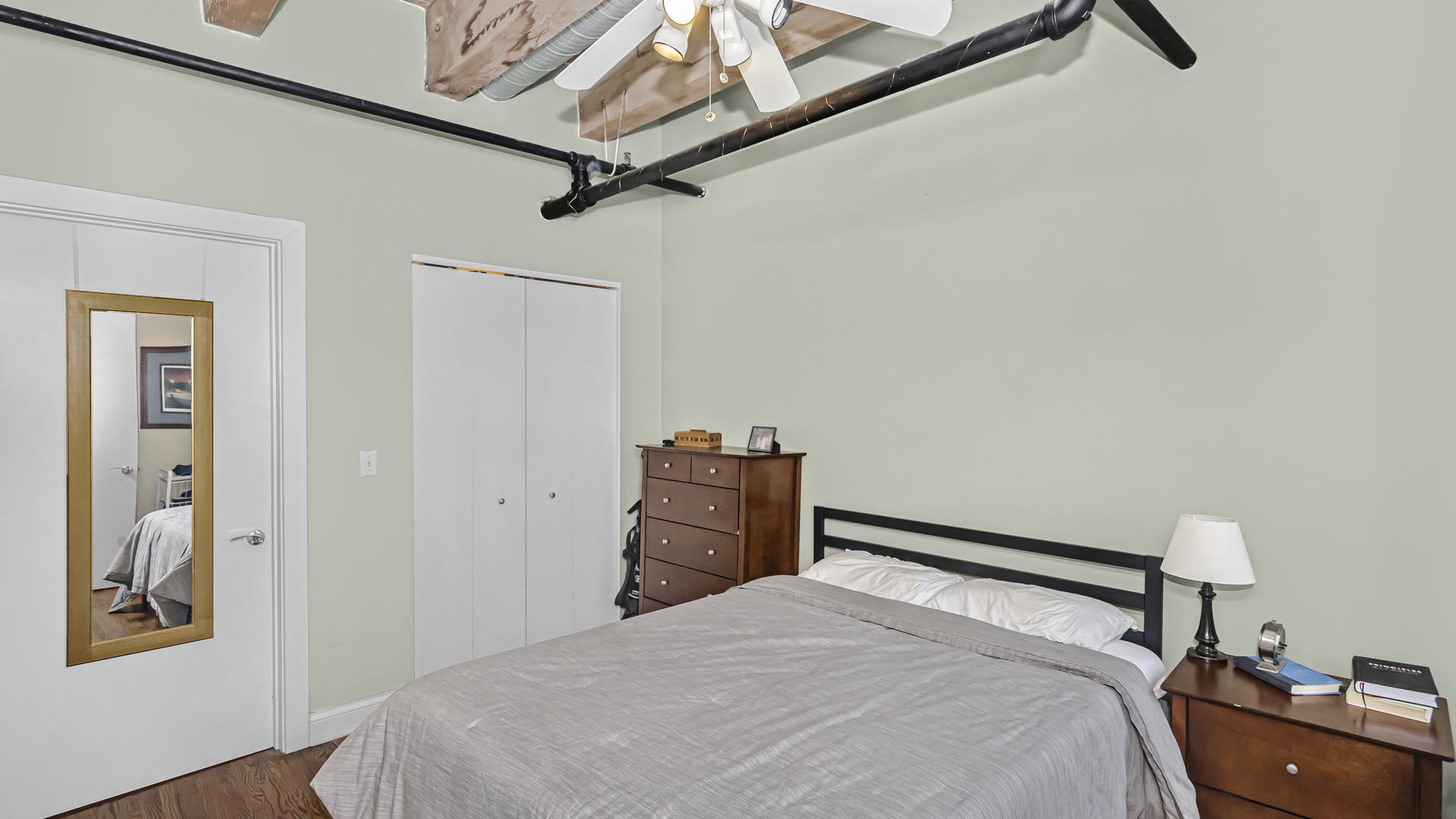 106 North Aberdeen Street, Unit 4G Chicago, IL 60607 - Photo 13 of 22 a bedroom with a bed and a chandelier