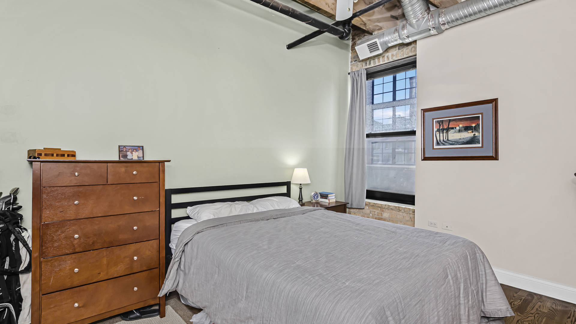 106 North Aberdeen Street, Unit 4G Chicago, IL 60607 - Photo 14 of 22 a bedroom with a bed and a dresser