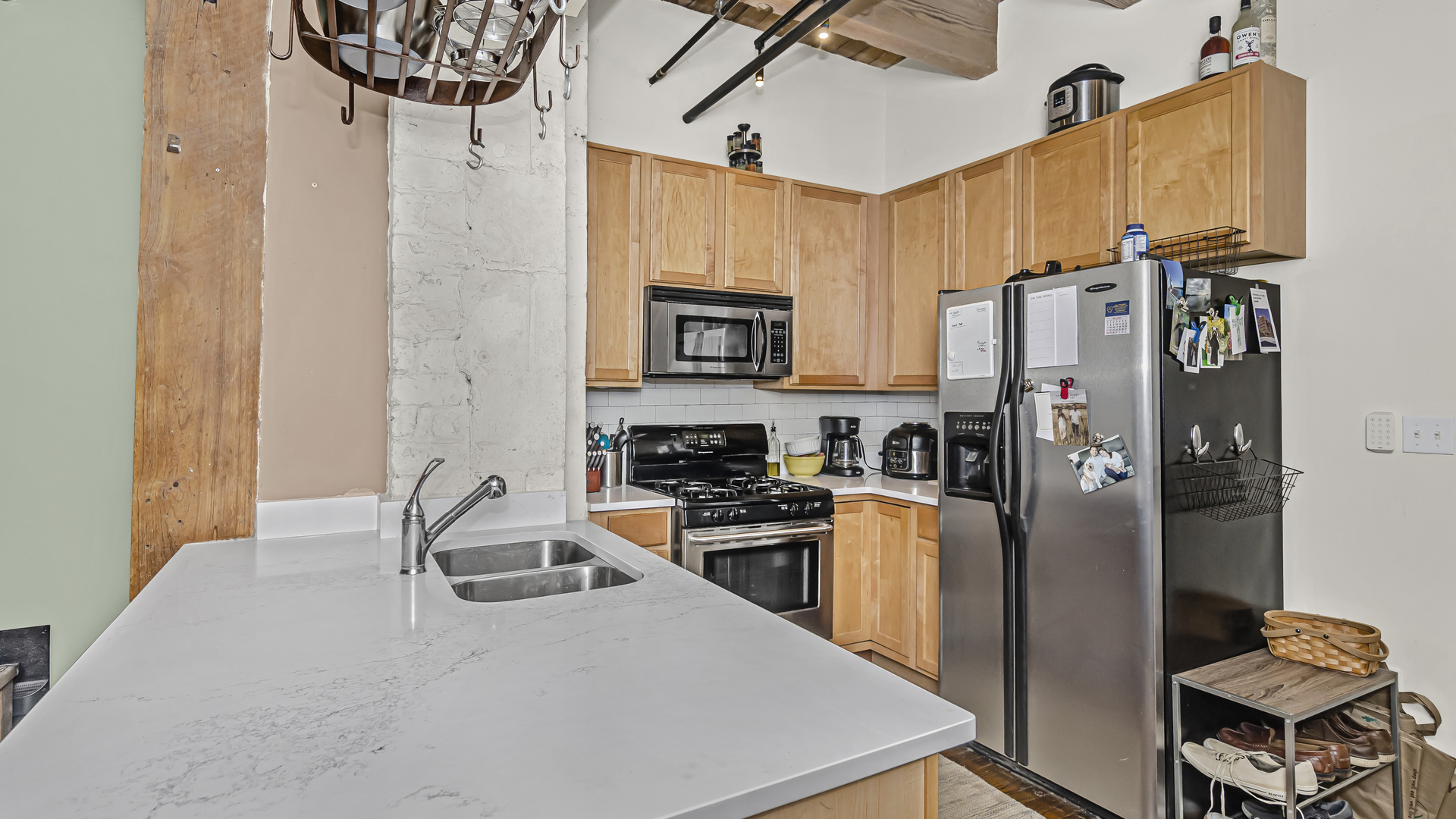 106 North Aberdeen Street, Unit 4G Chicago, IL 60607 - Photo 9 of 22 a kitchen with stainless steel appliances granite countertop a refrigerator a stove top oven a sink and dishwasher