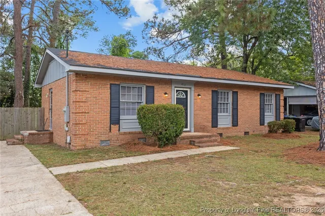 a view of a house with a yard and garage