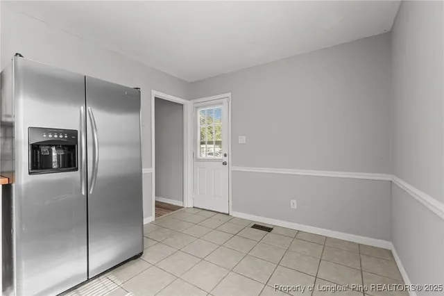 a kitchen with a refrigerator sink and cabinets
