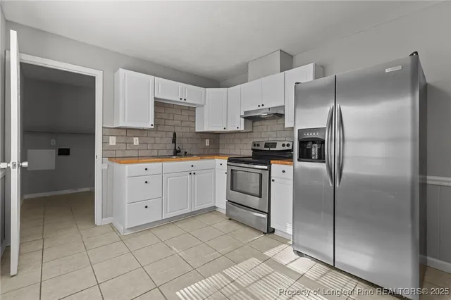 a kitchen with cabinets stainless steel appliances and a counter top