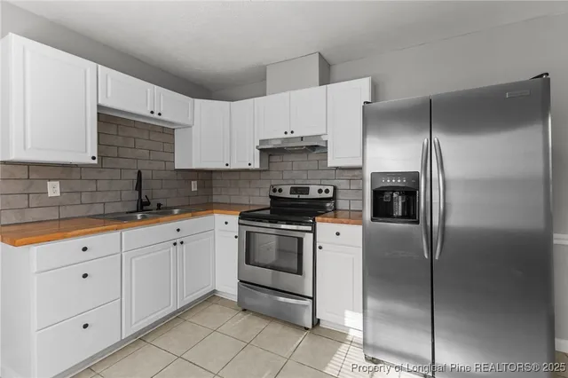 a kitchen with a stove a sink and a microwave