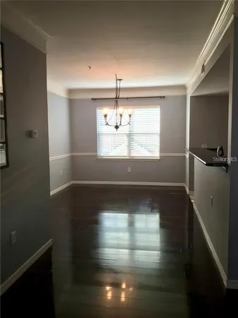 a view of a room with window and hardwood floor