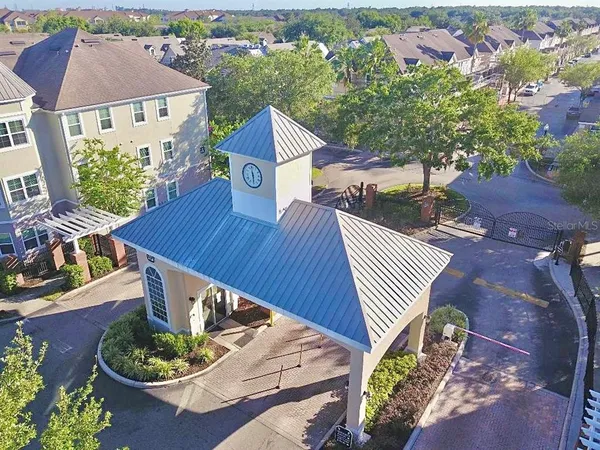 an aerial view of a house with a yard and outdoor seating