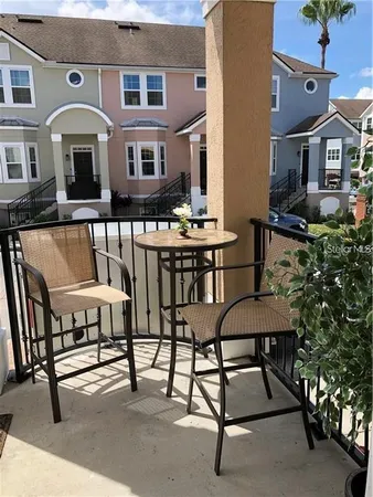a view of a patio with table and chairs with wooden floor and plants