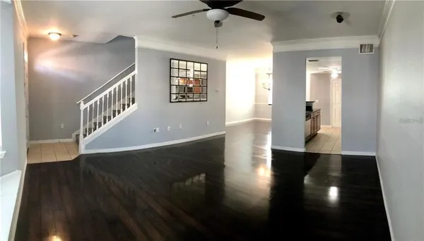wooden floor in a hall with a window and wooden floor