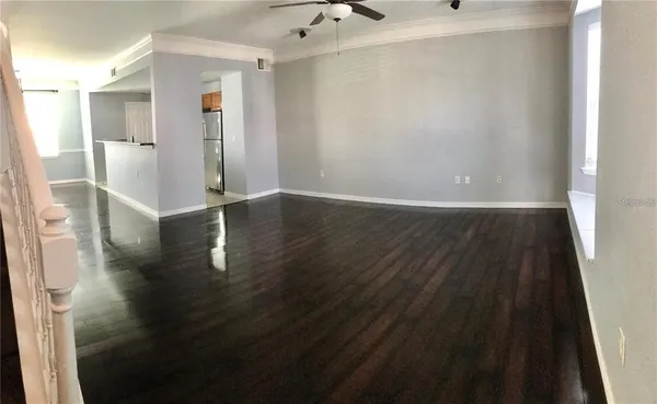 a view of a hallway with wooden floor