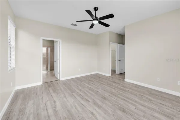 a bathroom with a granite countertop sink a mirror and a shower