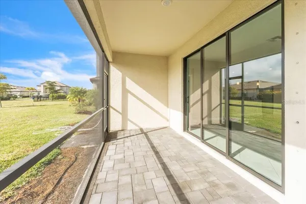 an aerial view of a house with yard swimming pool and ocean view