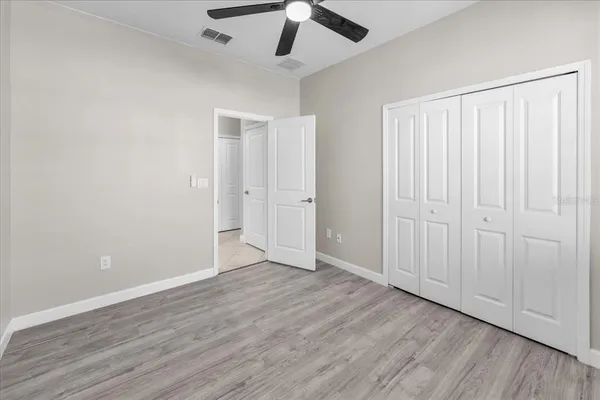 a bathroom with a granite countertop sink a toilet a mirror and bathtub