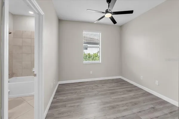 a view of an empty room with wooden floor