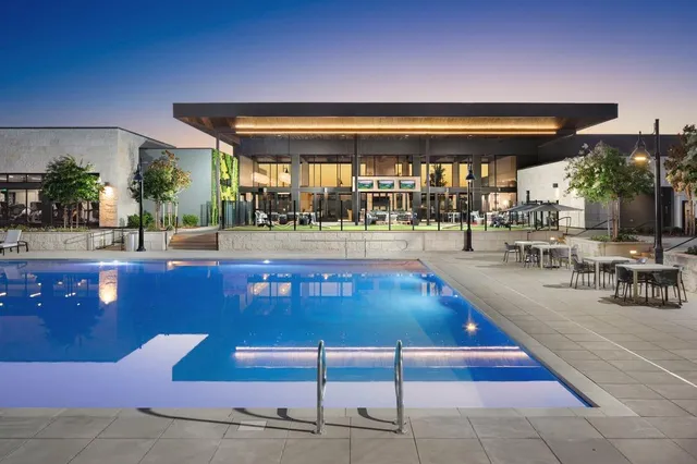 a lobby with furniture and potted plants