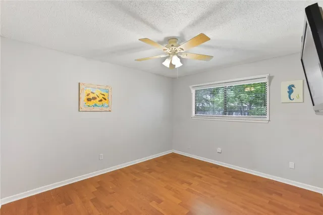 a bathroom with a granite countertop sink a mirror and shower