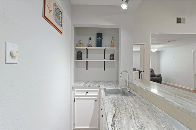 a view of a dining room with furniture and a chandelier fan