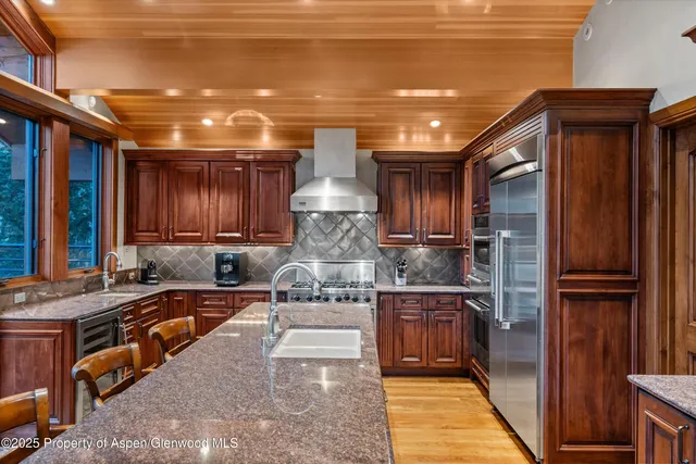 a bedroom with a bed and a dresser next to a window