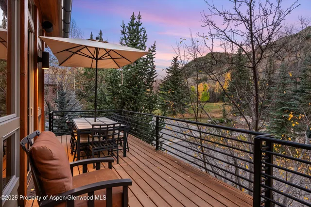 a bathroom with a granite countertop sink a toilet a mirror and shower
