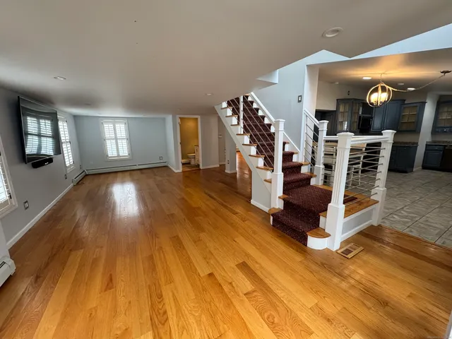 a view of a room with wooden floor