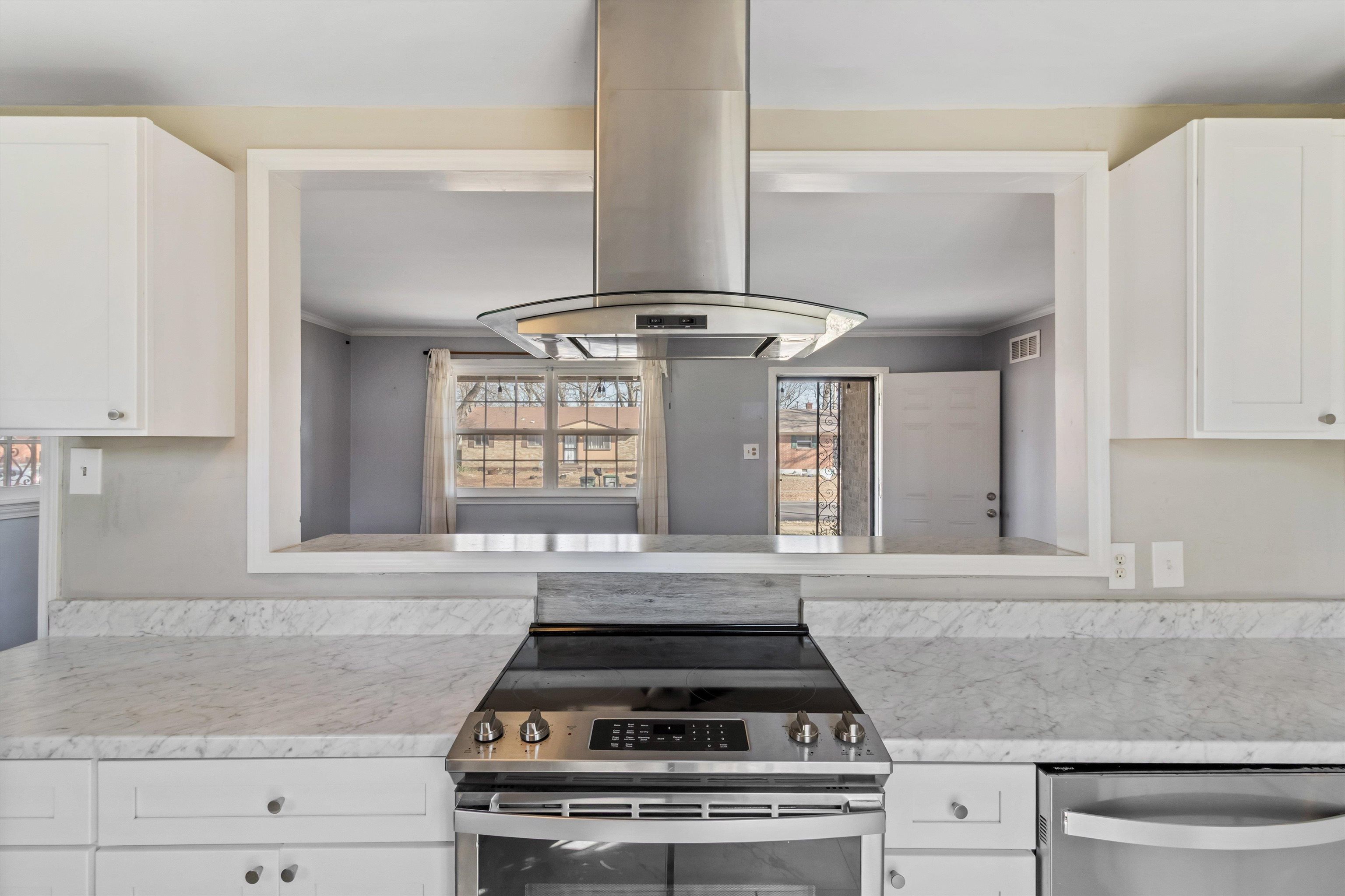 517 Malboro Road Memphis, TN 38120 - Photo 11 of 25 Kitchen featuring white cabinets, island exhaust hood, stainless steel appliances, ornamental molding, and light stone counters