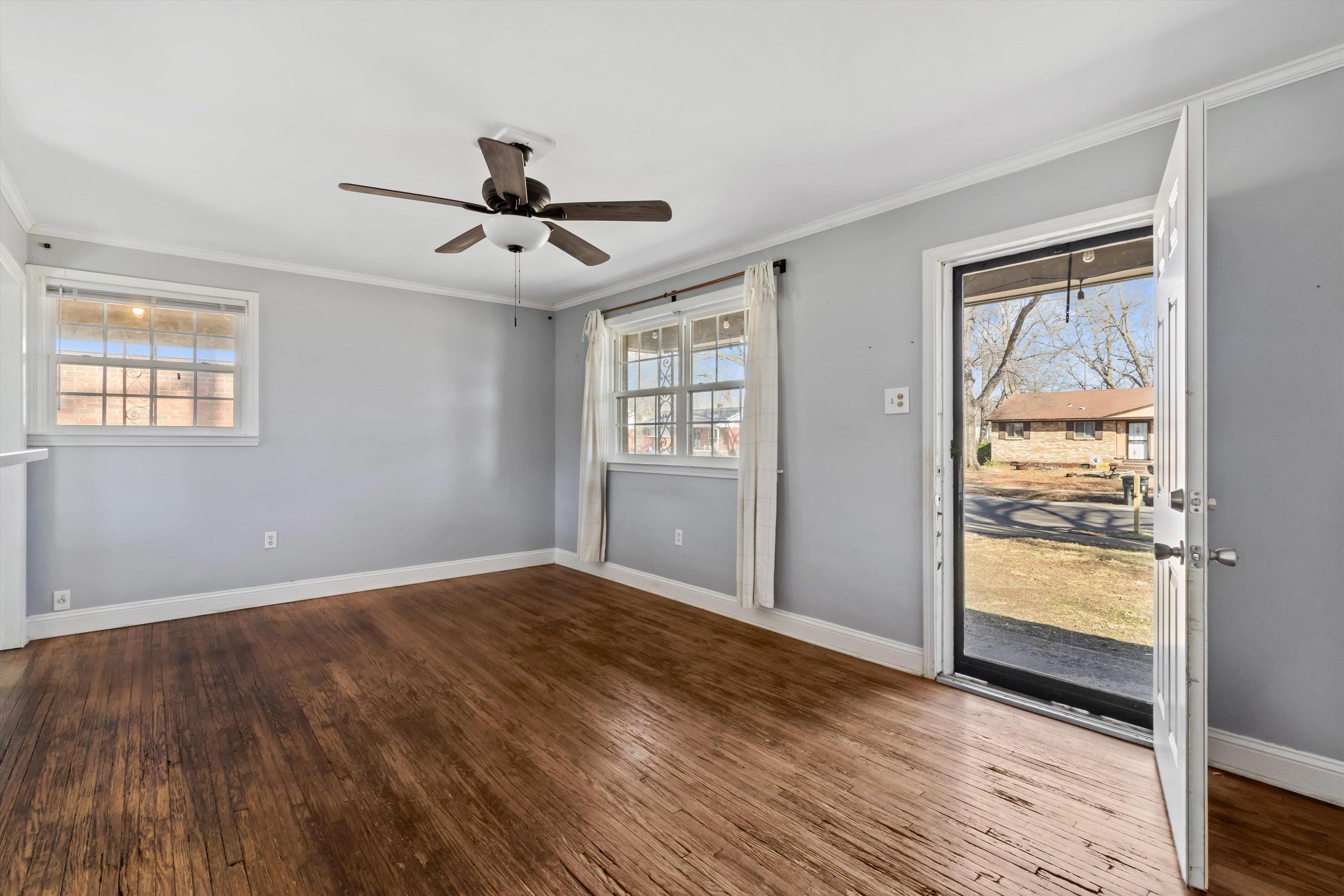 517 Malboro Road Memphis, TN 38120 - Photo 5 of 25 Unfurnished room featuring hardwood / wood-style floors, crown molding, and ceiling fan