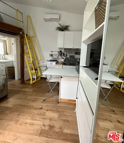a view of a kitchen with furniture and a wooden floor