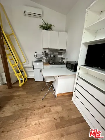 a living room with patio furniture and a flat screen tv