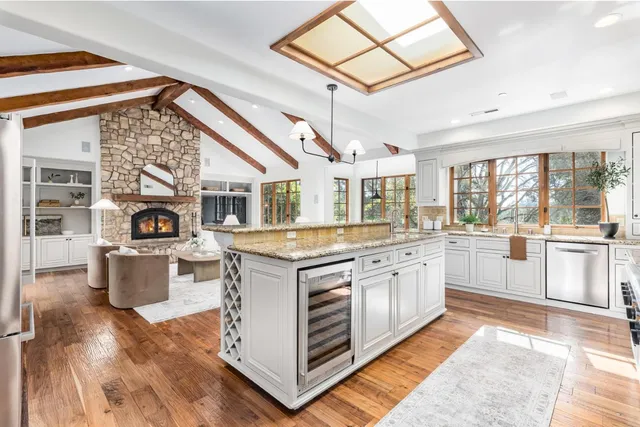 a kitchen with stainless steel appliances granite countertop a stove and a sink